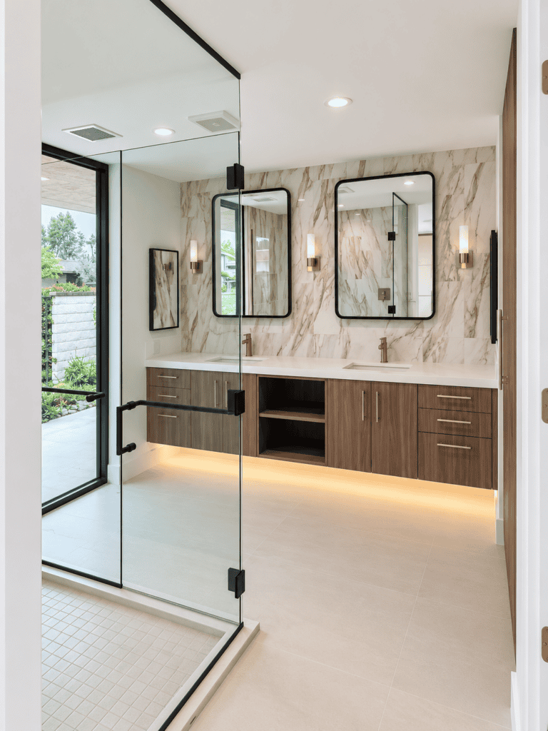 Contemporary bathroom with tile vanity, mirrors, and glass shower enclosure.